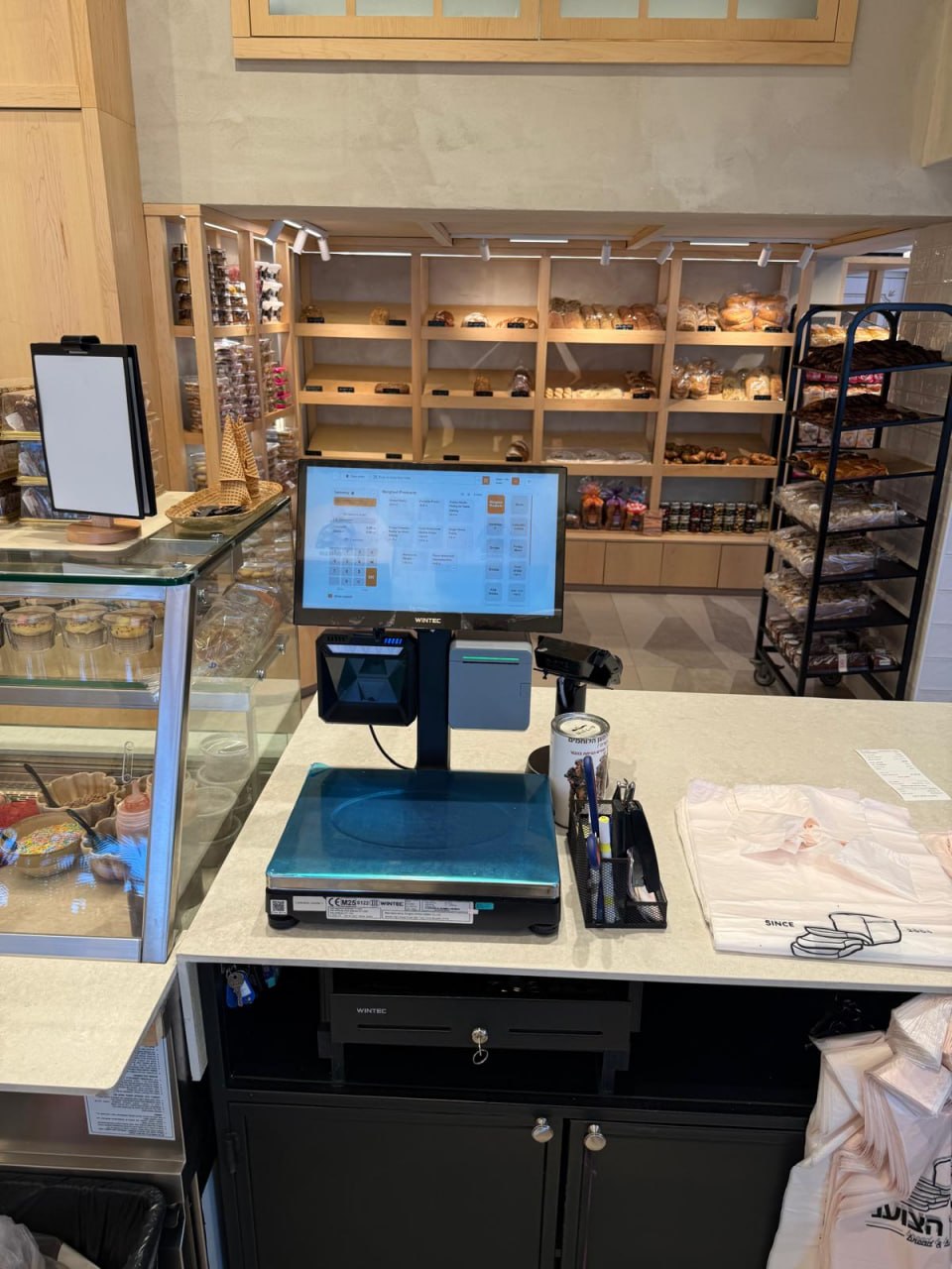 Staff sales station with a scale, scanner and printer in a bakery